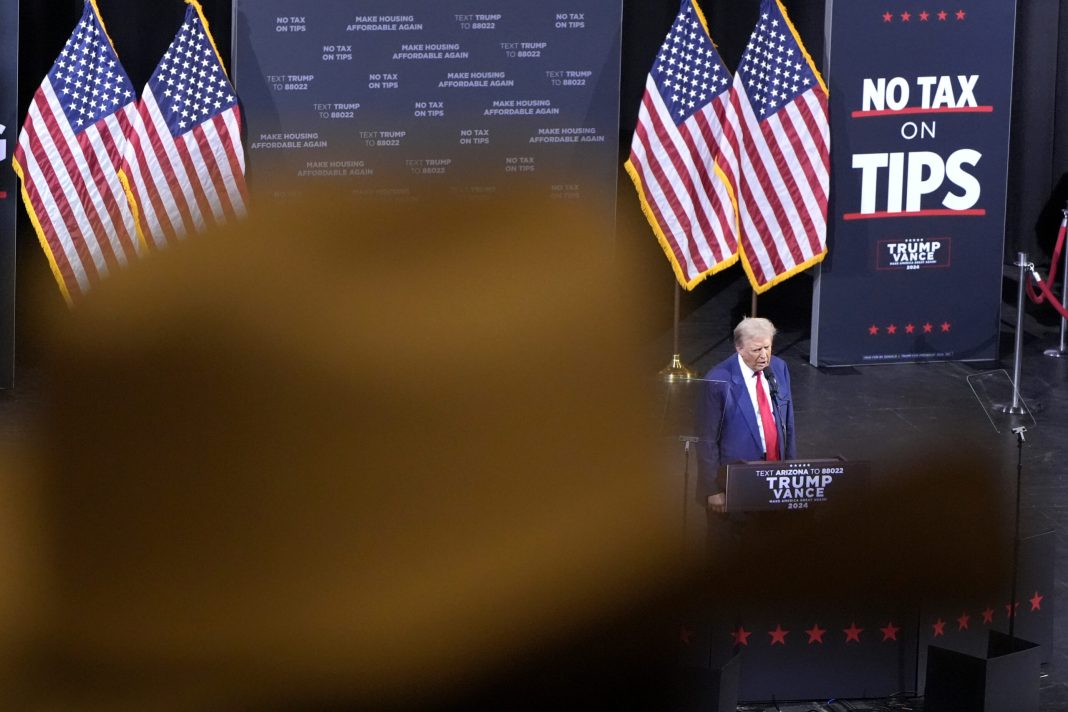 FILE - A supporter listens as Republican presidential nominee former President Donald Trump speaks ...